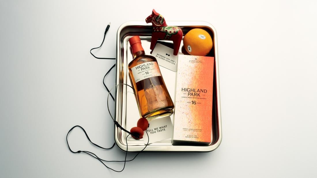 A bottle of Highland Park Between You & I, laid in a metal box
