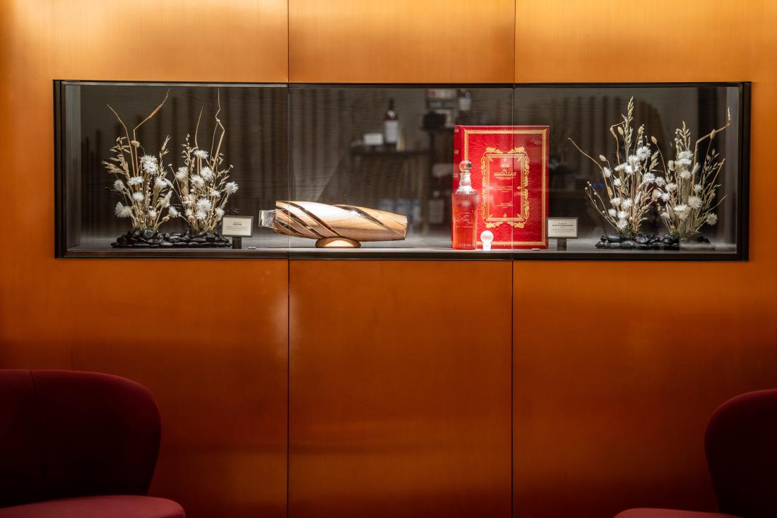 A display shelf built into wall, showing two rare bottles of The Macallan