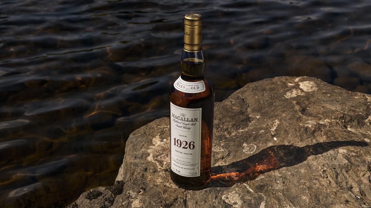 Bottle of The Macallan 1926 sitting on top of a rock next to River Spey