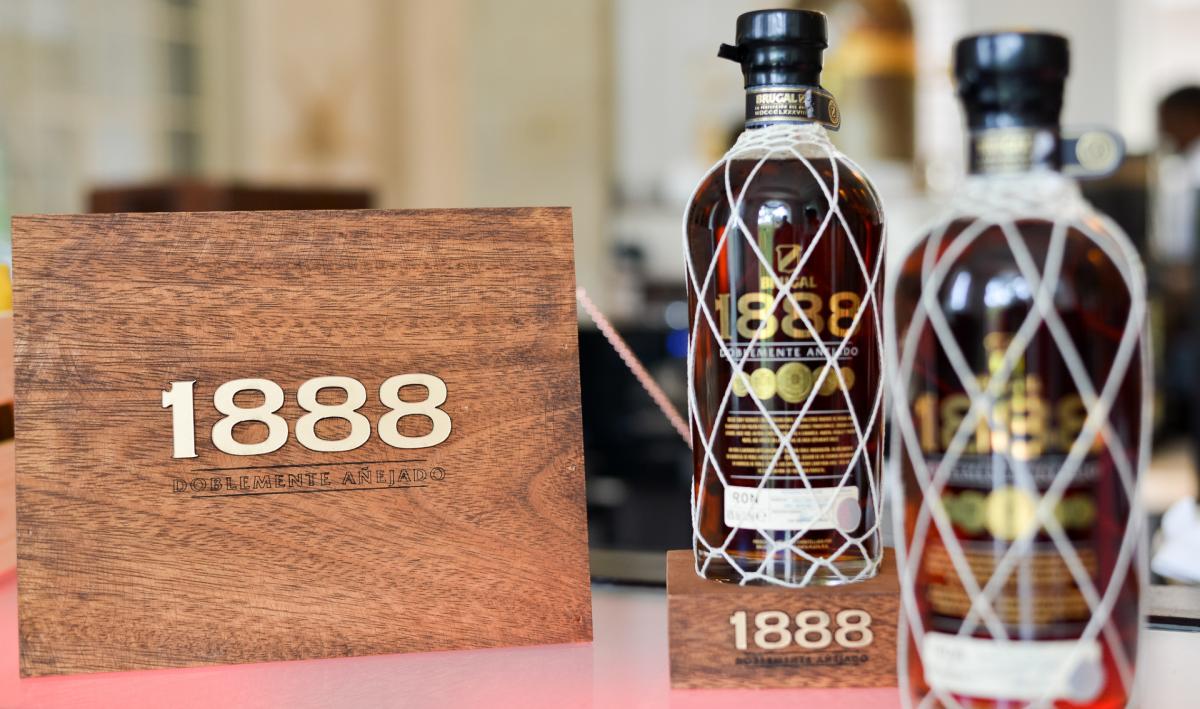 Two bottles of 1888 next to a branded wooden pack