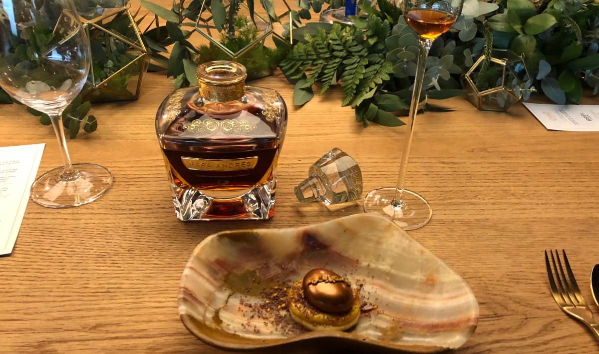 Bottle of Papa Andres next to a desert on a table