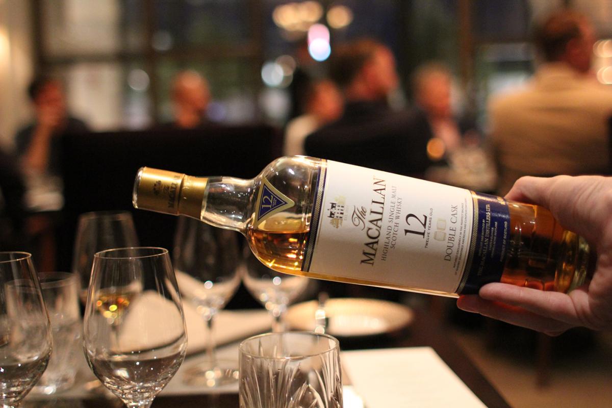 A measure of The Macallan 12 is being poured into a glass