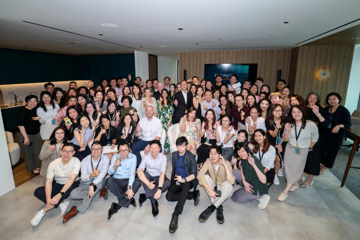 A large group of 70 colleagues getting a group picture taken in the Singapore office