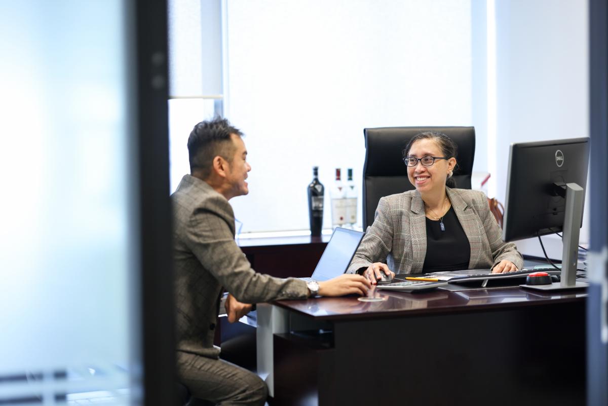 Two colleagues in an office chatting