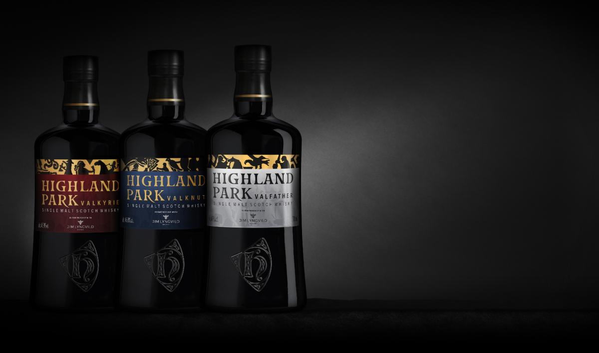 Three bottles of Highland Park lined up on left hand side of image in front of dark backdrop