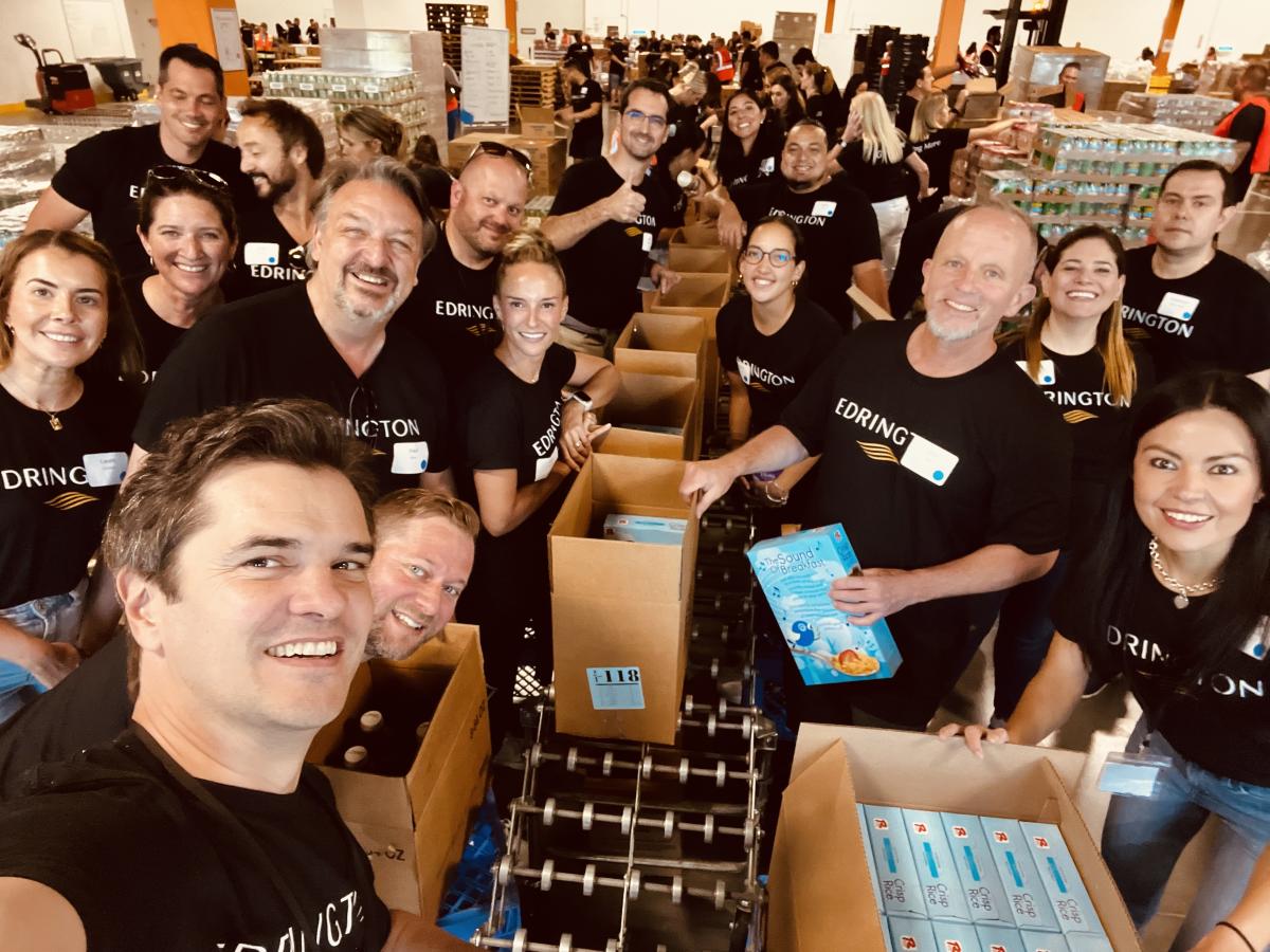 Americas colleagues packing food items on a Giving More day