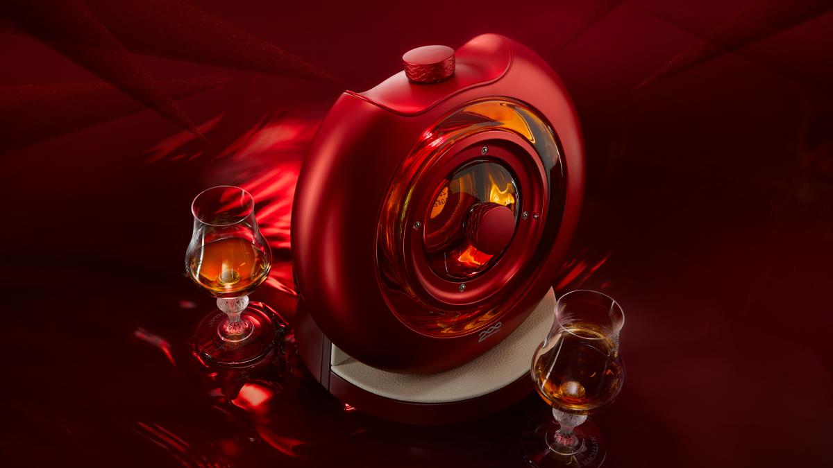The Macallan TIME : SPACE red circular vessel next to two whisky glasses