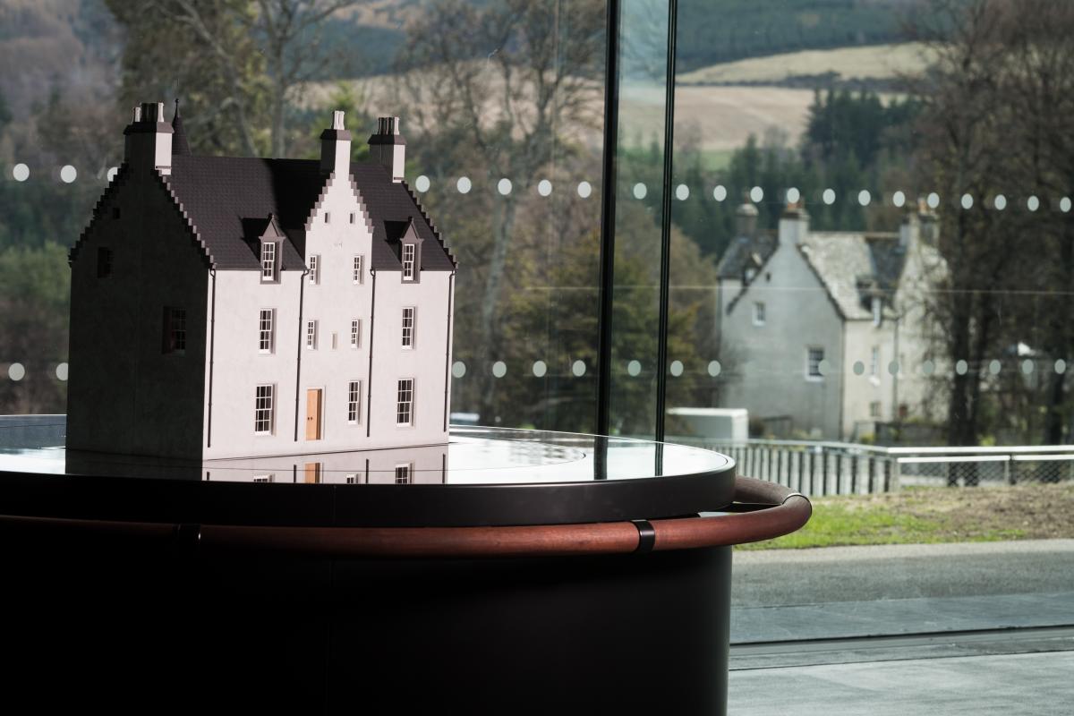 Model of Easter Elchies House, home of The Macallan, with the real house in the background