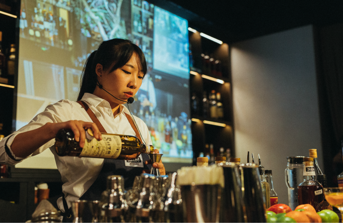 A bartender mixing a Naked Grouse cocktail in a bar