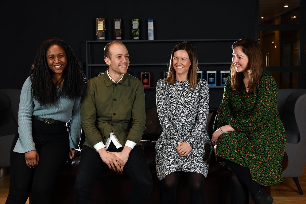 Four Edrington colleagues sitting in a row chatting