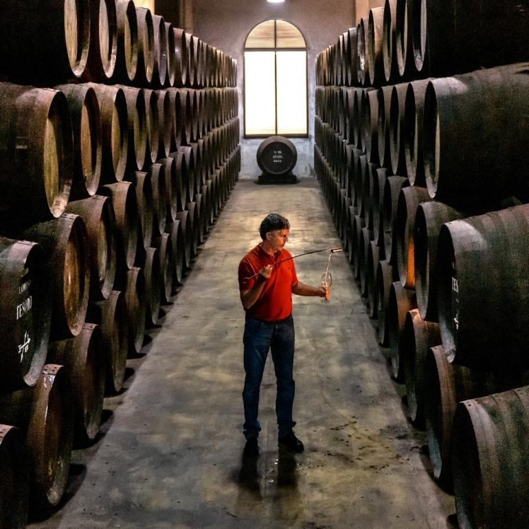 A man samples Sherry in a traditional Jerez Bodega