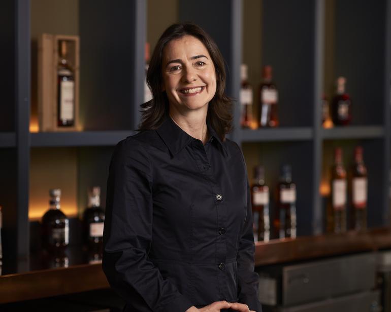 Head and shoulders portrait shot of Suzy Smith in front of Queen Street Bar